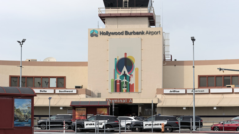 Terminal A at Hollywood Burbank Airport with police cars out front.