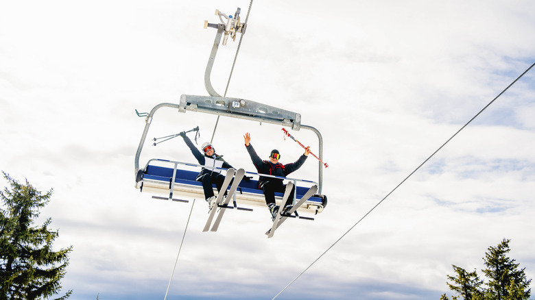 happy skiers on a chairlift