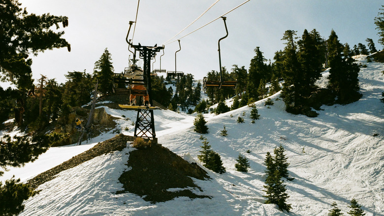 snowboarder on a chairlift gives thumbs up at Mt. Baldy ski area