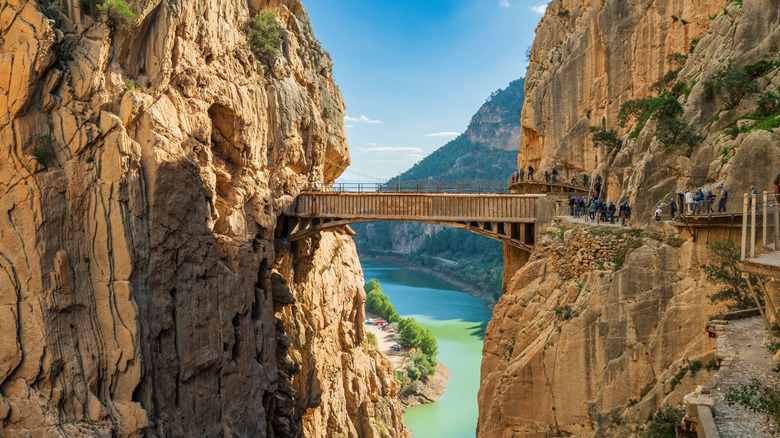 A wooden walkway between two huge limestone mountains at the Caminito del Rey walkway in Spain