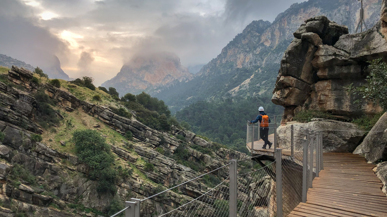 A person staring out from a viewpoint on the Caminito del Rey near Málaga in Spain