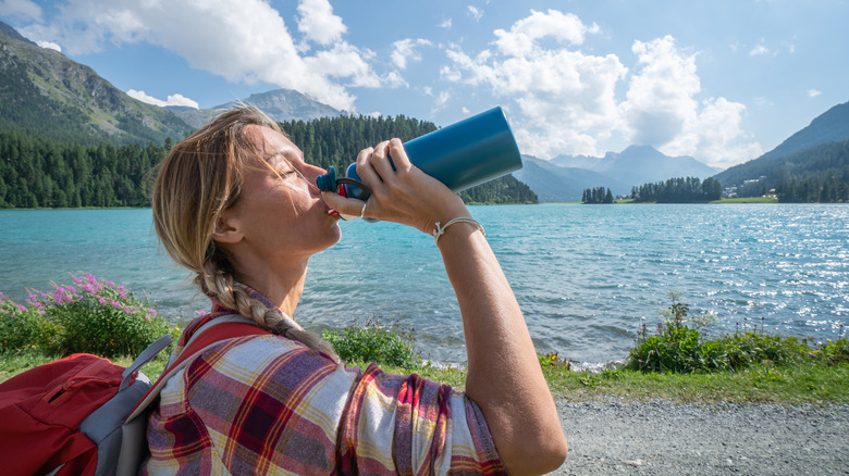 Female hiker drinking water 