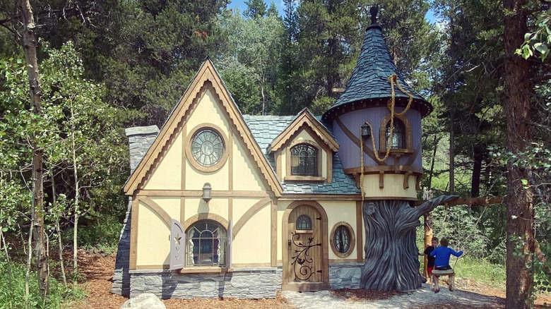quaint fairytale cottage with children playing outside