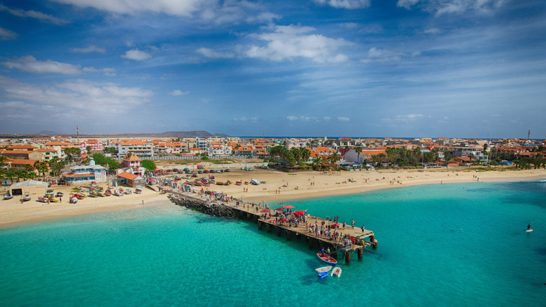 Pier along a beach in turquoise water