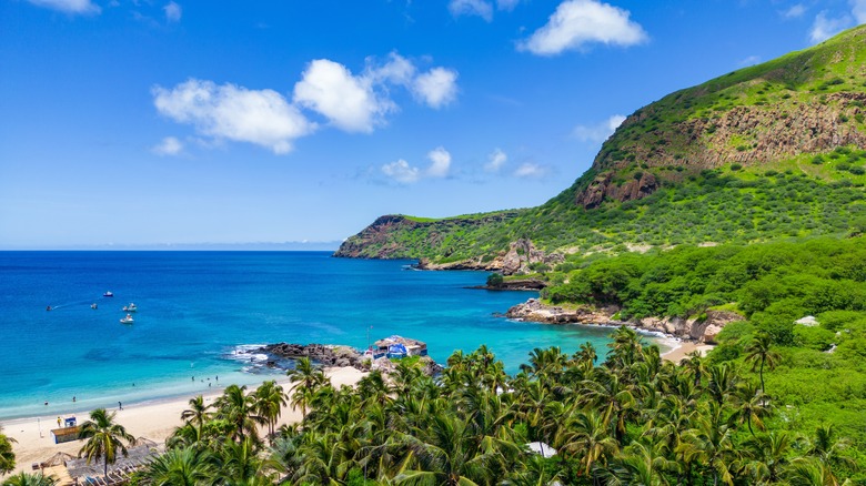 Tropical landscape with blue water and green mountains