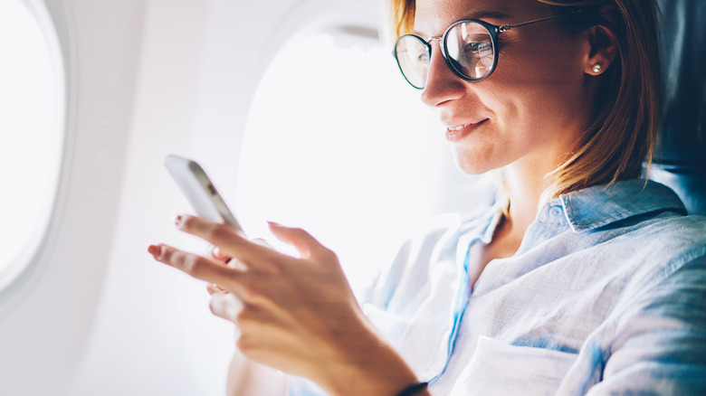 happy woman in airplane seat