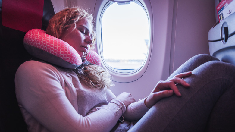 Woman sleeping with a neck pillow 