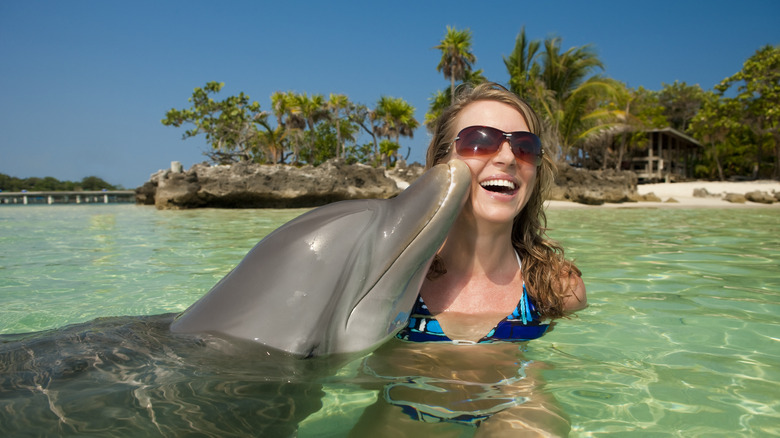 Woman swims with dolphin