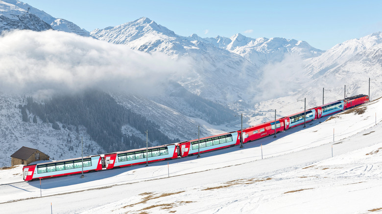 Red Glacier Express going uphill on a snowy mountain