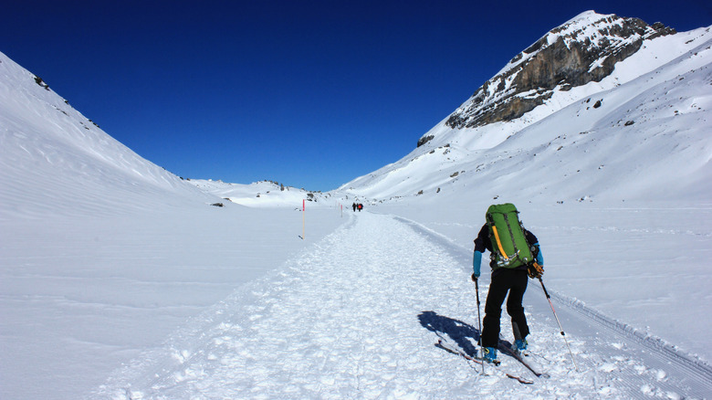 A cross-country skier on a groomed trail near Lake Oeschinen in Kandersteg, Switzerland.