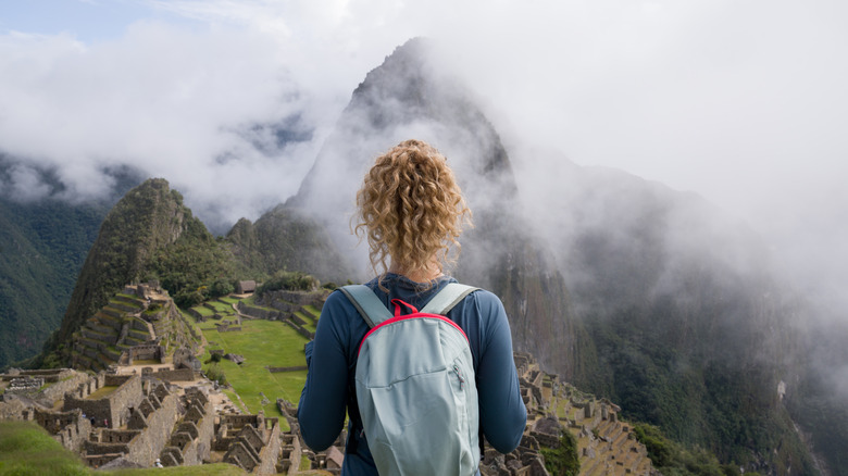 Tourist facing Machu Picchu