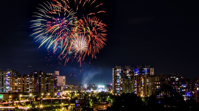 Firework display over city skyline