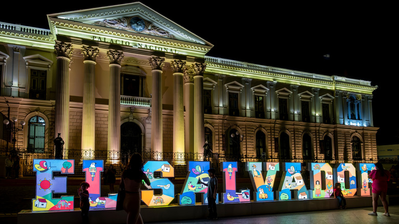 Colorful sign El Salvador in front of the National Palace in downtown historical center of the capital city at Civic Square.