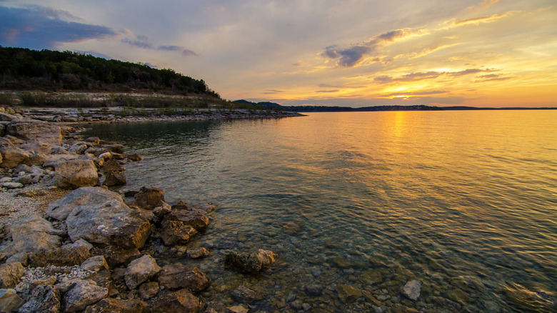 sunset over lake with rocks