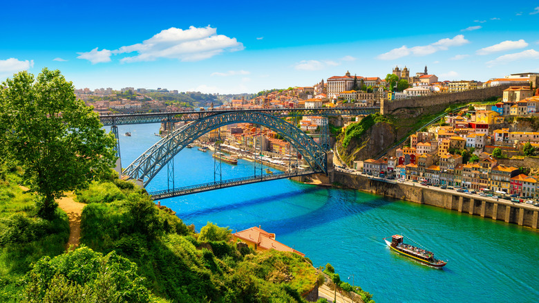 Beautiful view of a bridge spanning a river in the city of Porto on a beautiful summer day.