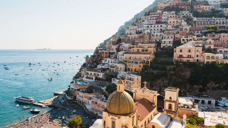 Positano's colourful cityscape with leisure and fishing boats on the sea