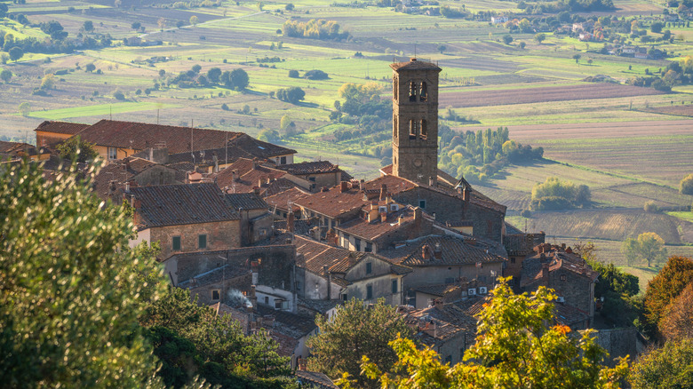 View of Cortona village from above and view of Val di Chiana