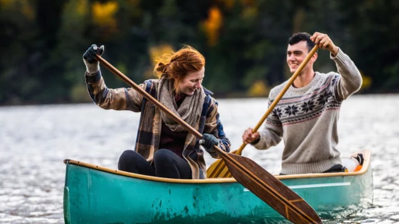 couple paddling canoe