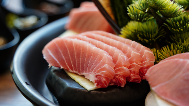 Close-up of Sliced Tuna Sashimi on Black Plate