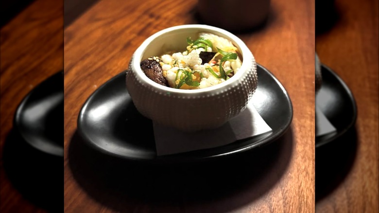 Diners sitting at an elegant, retro bar in Lazy Betty, Atlanta