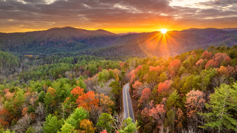 Scenic road through fall foliage in Blue Ridge Mountains at sunset