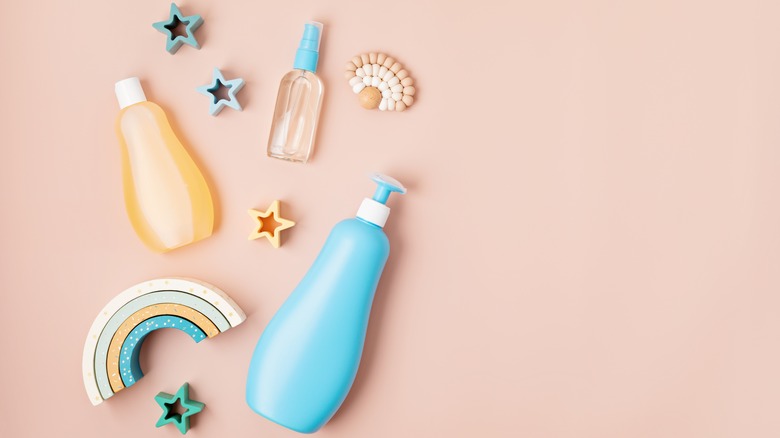 toiletry bottles on pink background