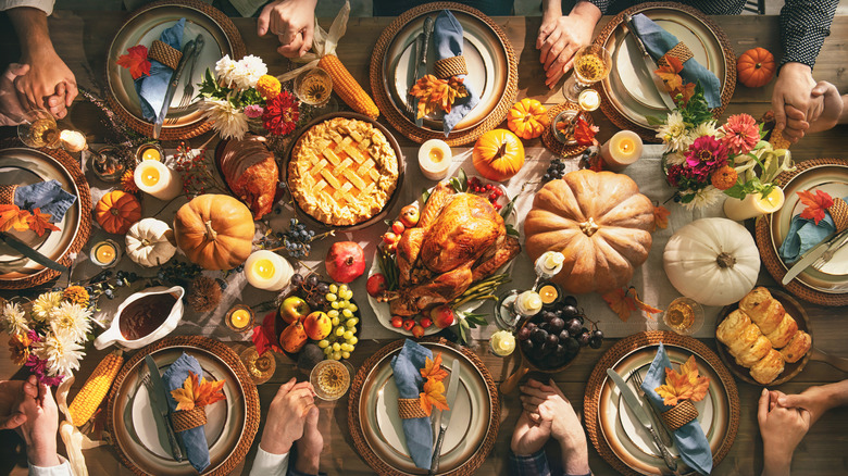 People gathered around Thanksgiving table