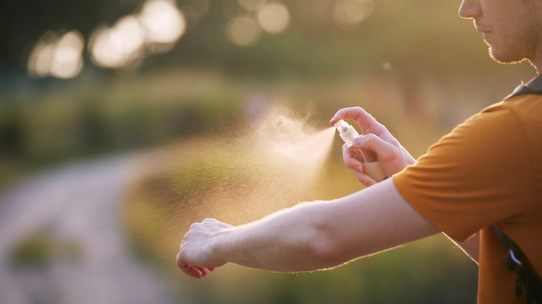 Man applying homemade bug spray