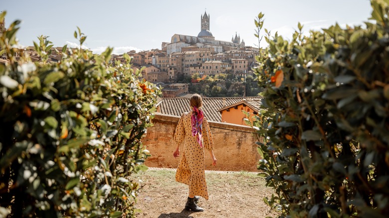 Woman walks towards Siena