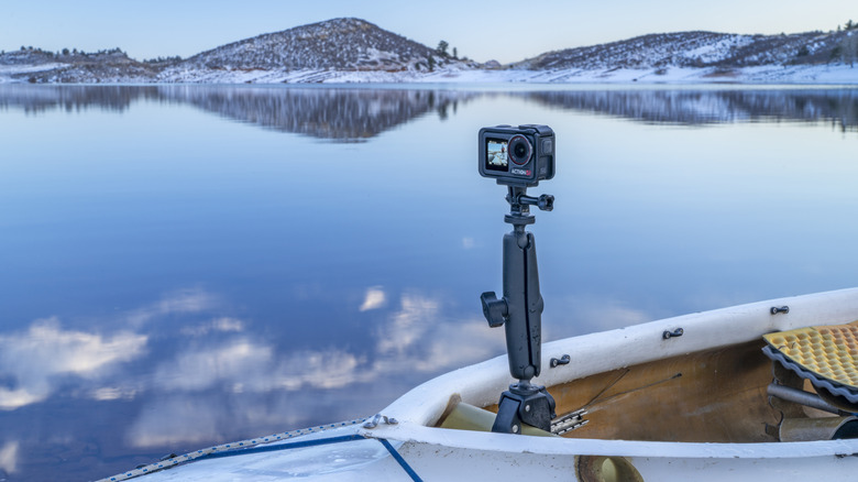 a small action camera mounted on a boat on a lake
