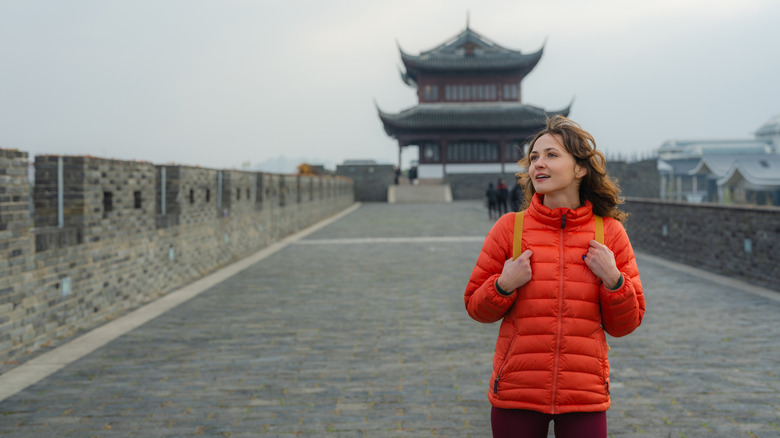Woman walking on Xiangmen Ancient City Wall in Suzhou during trip to China