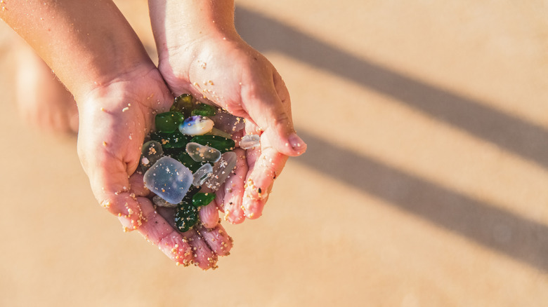 Hands holding sea glass found on a beach