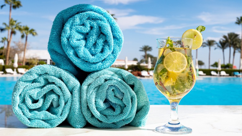 pool towels and mojito outdoors