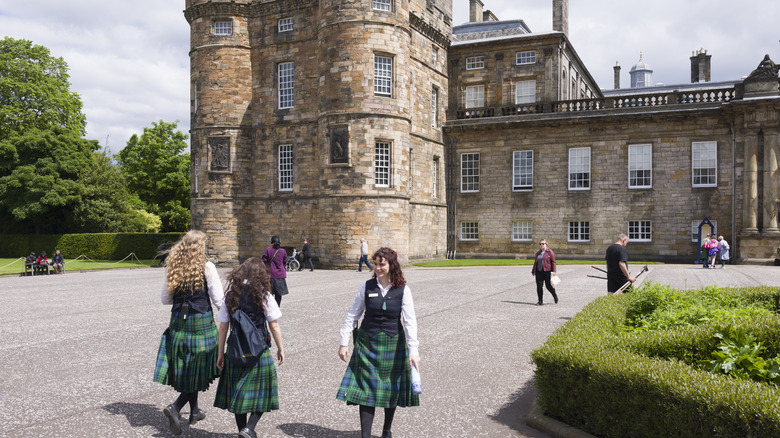 Scottish castle with tour guides in plaid
