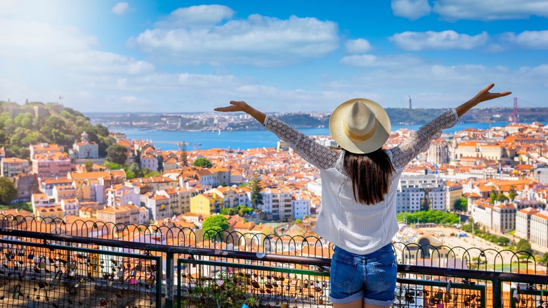 Lady viewing Alfama town in Lisbon