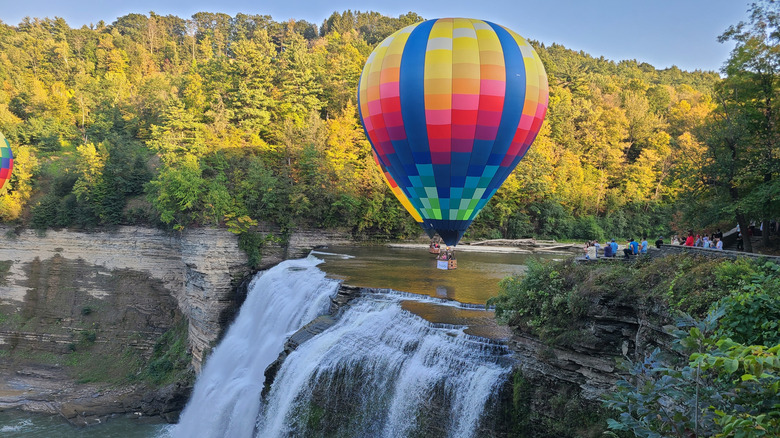 Hot air balloon over waterfall