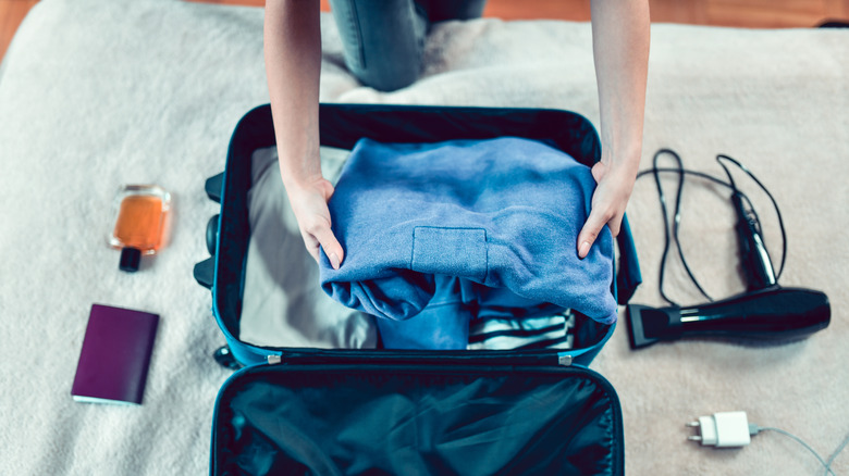 Packing a suitcase with perfume 
