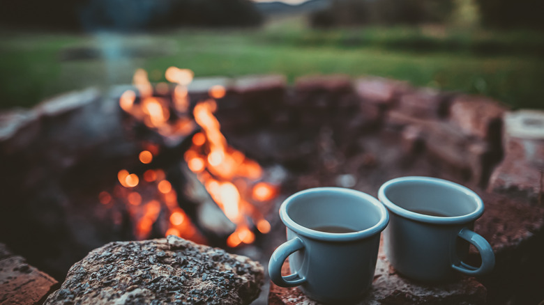Coffee next to campfire