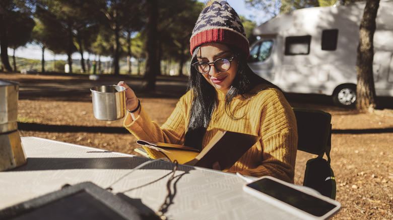 Woman drinking coffee at campground