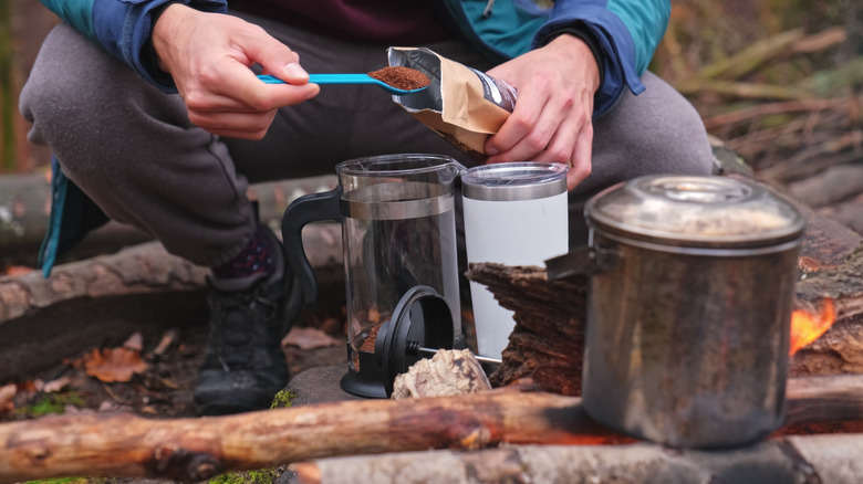 Preparing French press coffee at camp