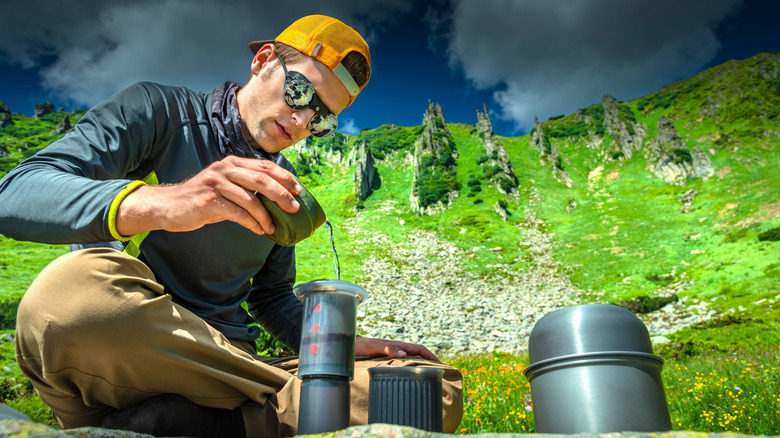 Man making AeroPress coffee