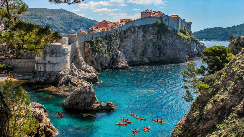 kayakers outside walled village