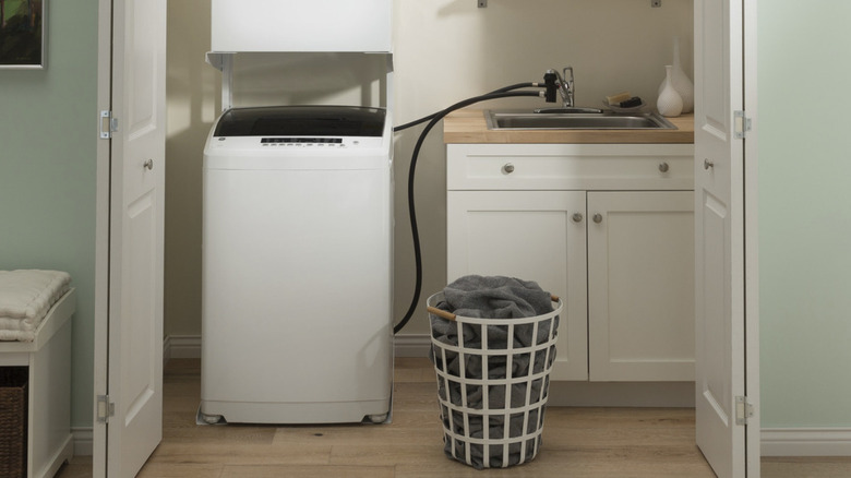 laundry room with a GE Space-Saving 2.8 cu. Ft. Portable Washer