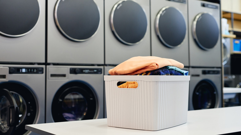 laundry basket filled with laundry at a laundromat