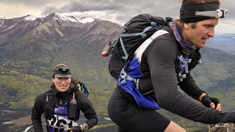 Two trail runners heading up steep terrain