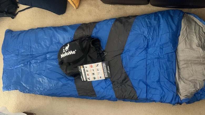 the The MalloMe Everyday 3 Season Camping Sleeping Bag in blue laid out on the ground