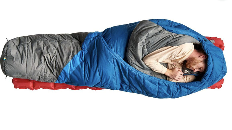person sleeping in the  The Sierra Designs Night Cap 20 degrees F Sleeping Bag