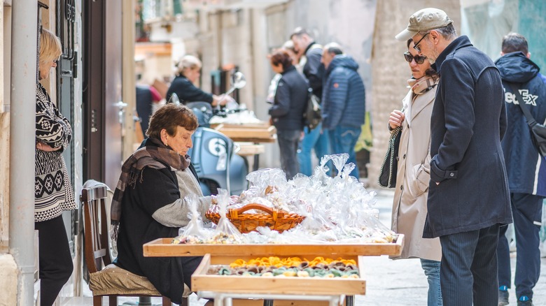 Tourists buying pasta in Bari