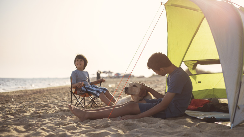 family with beach tent