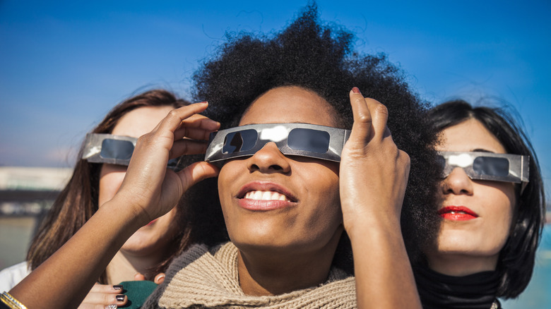 Friends watching solar eclipse